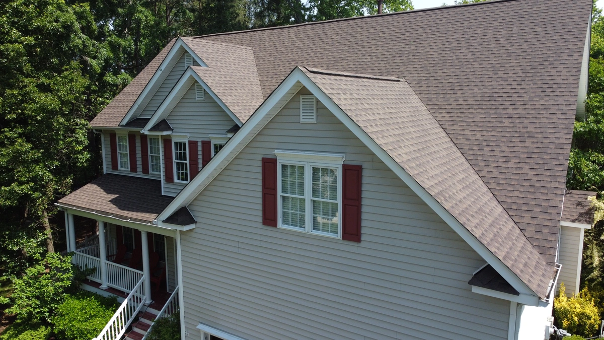 close up to beige vinyl siding and windows