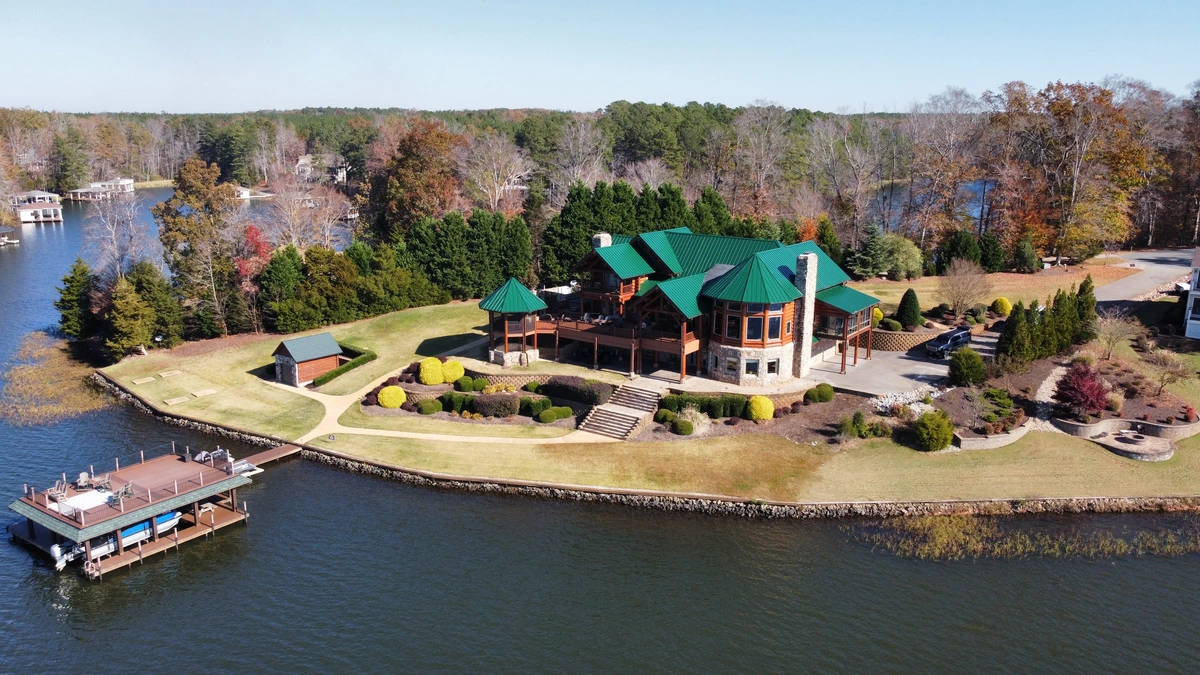 large home with wood siding and metal roof