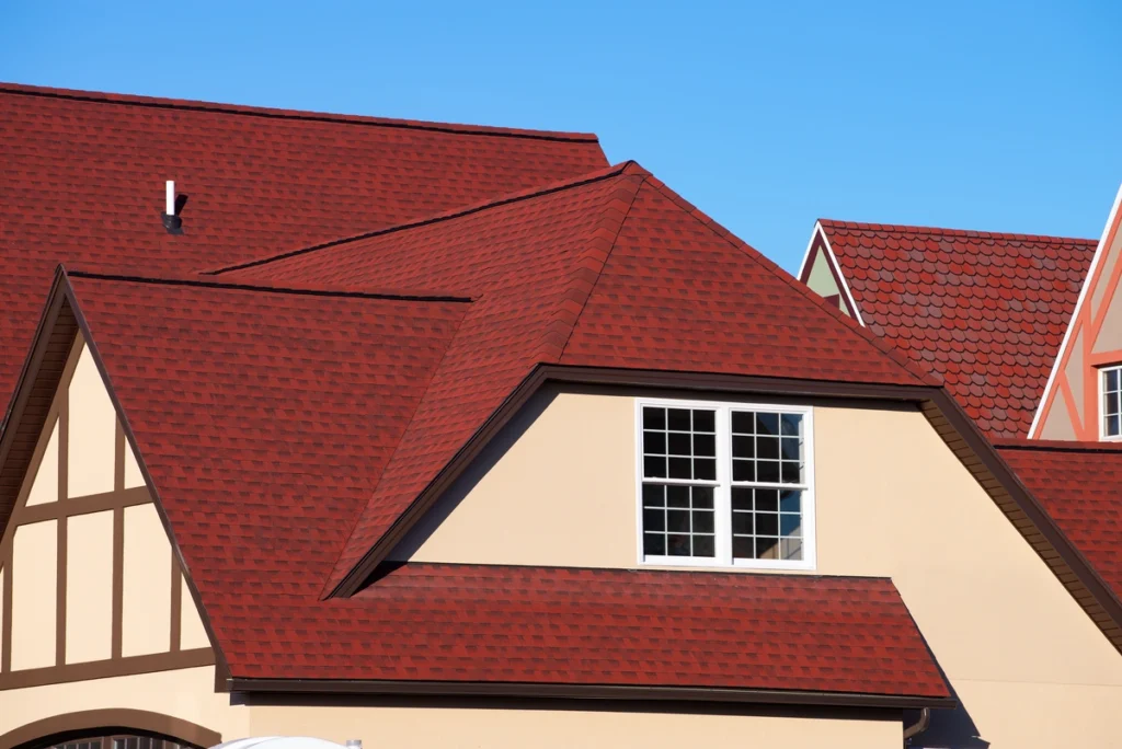 red asphalt shingles on the house roof