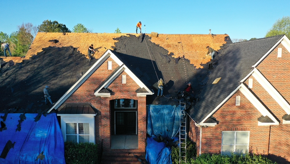 roofing crew professionally replacing the old shingles