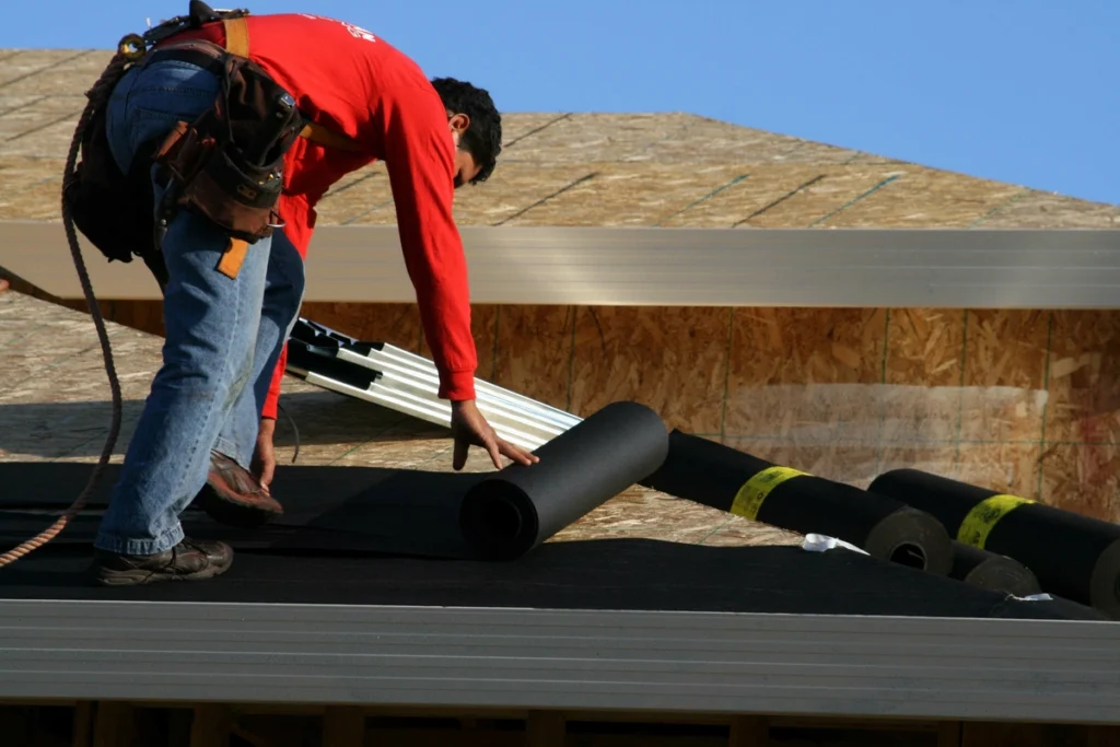 worker on plywood roof
