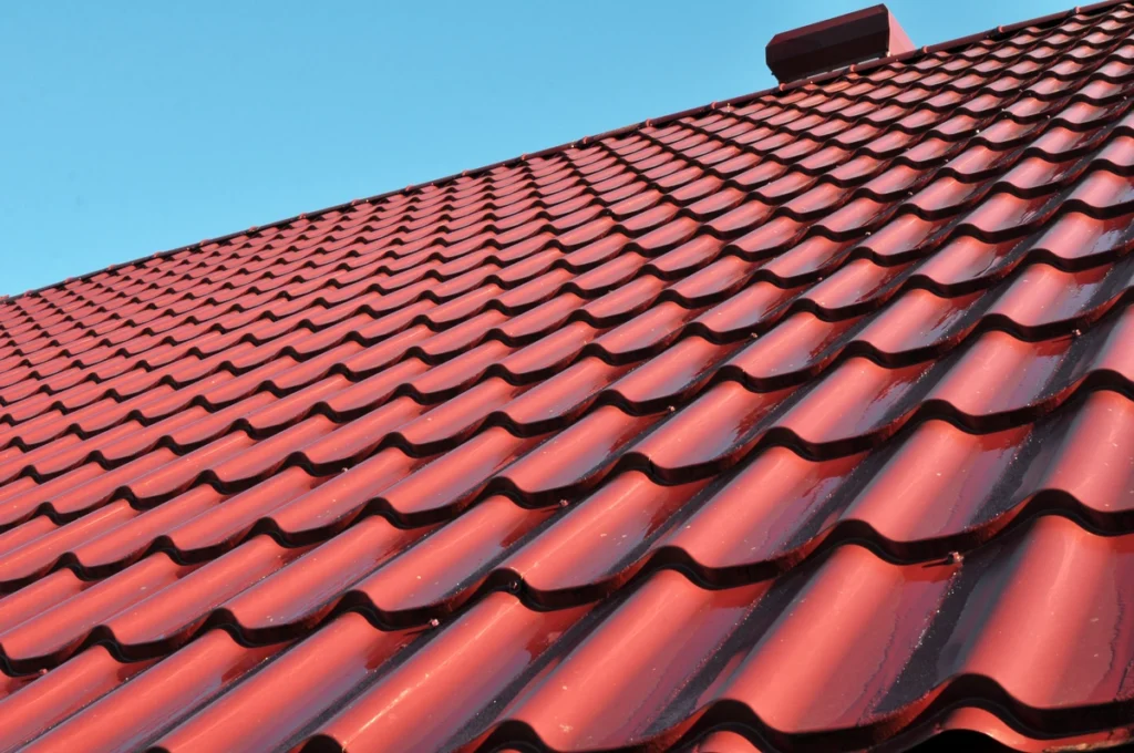red metal shingles on roof close up 