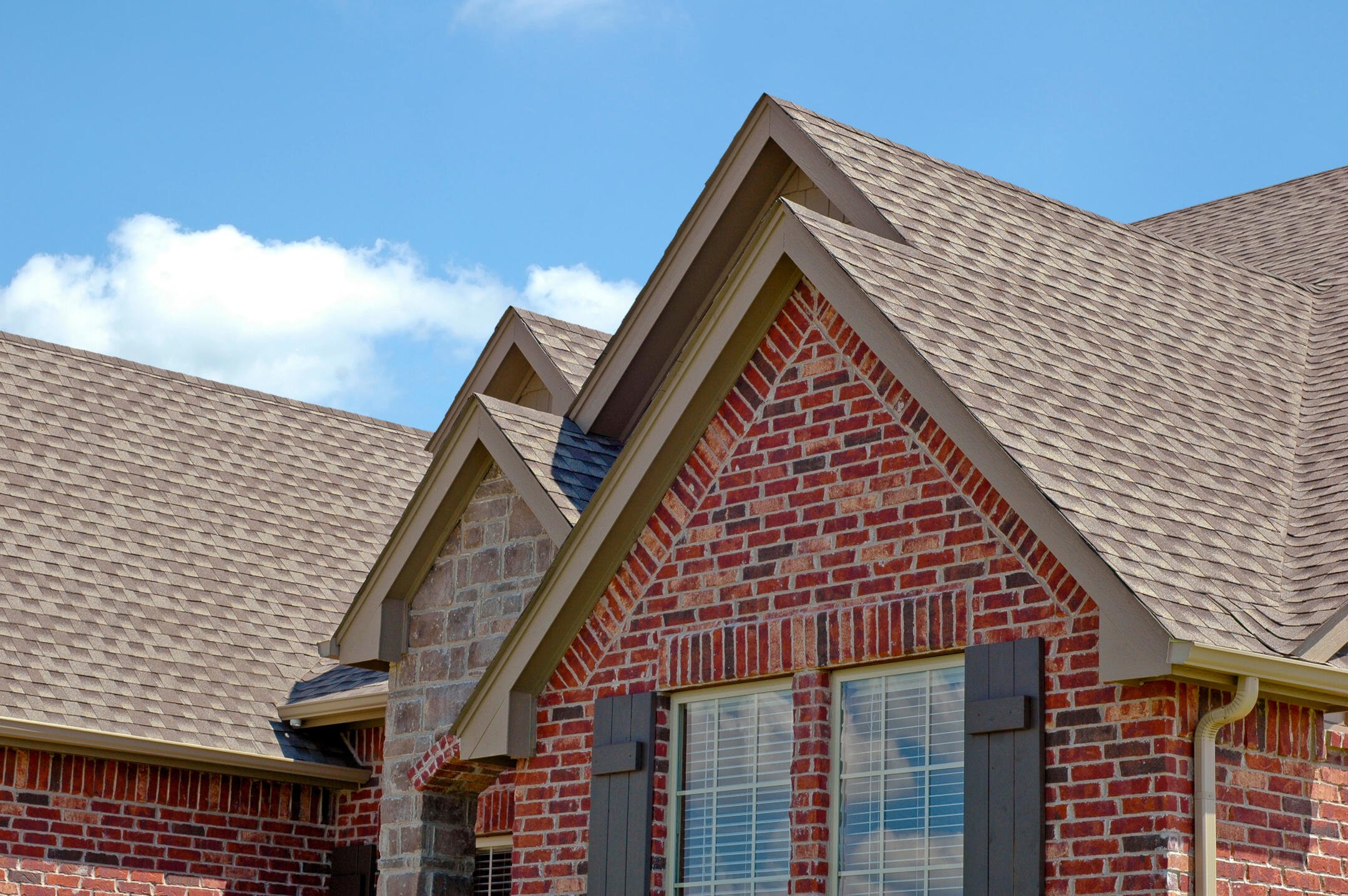 roofing henderson nc-red brick house with gray shingles