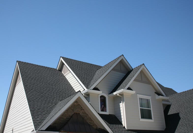 roofing henderson nc-white sided house with dark gray shingles
