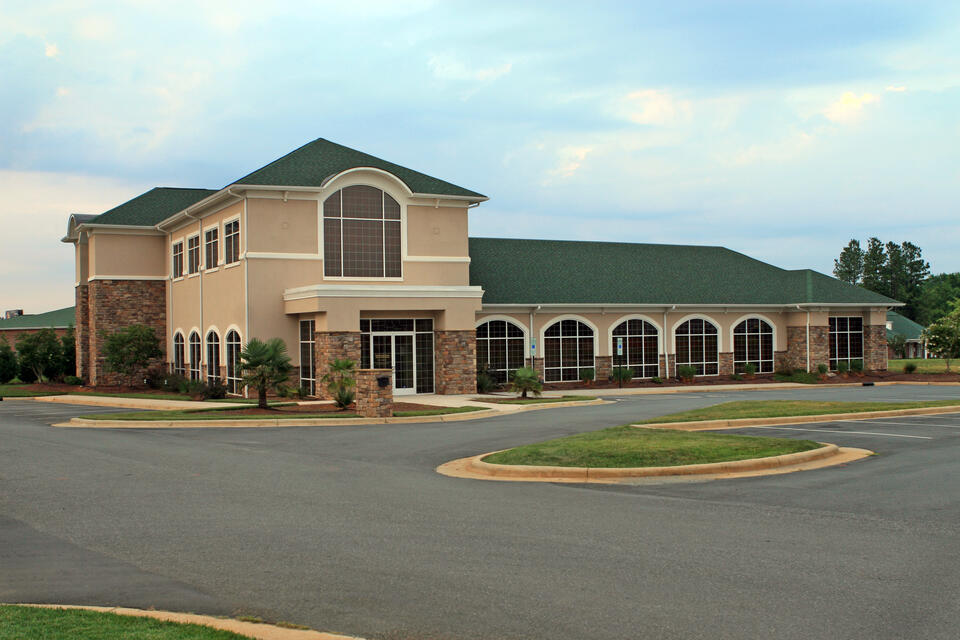 commercial roofing henderson nc-tan building with green roof