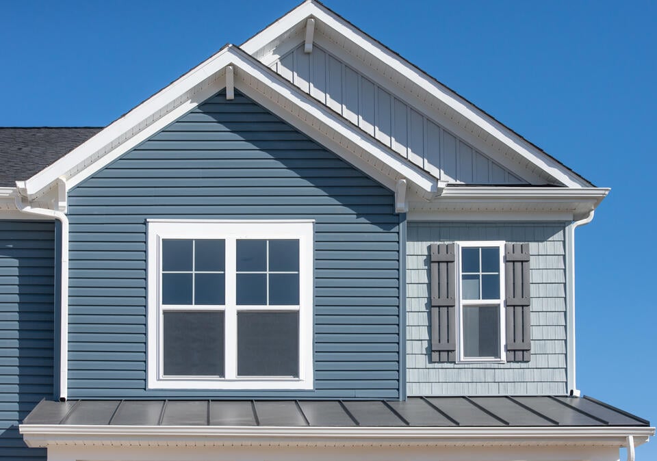 blue sided house with metal roofing