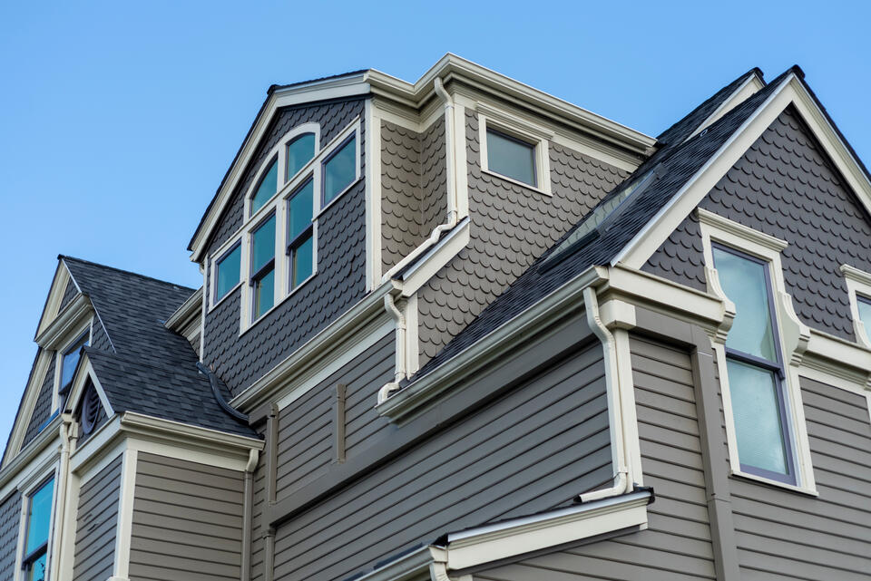 gray sided house with white siding and black architectural shingles
