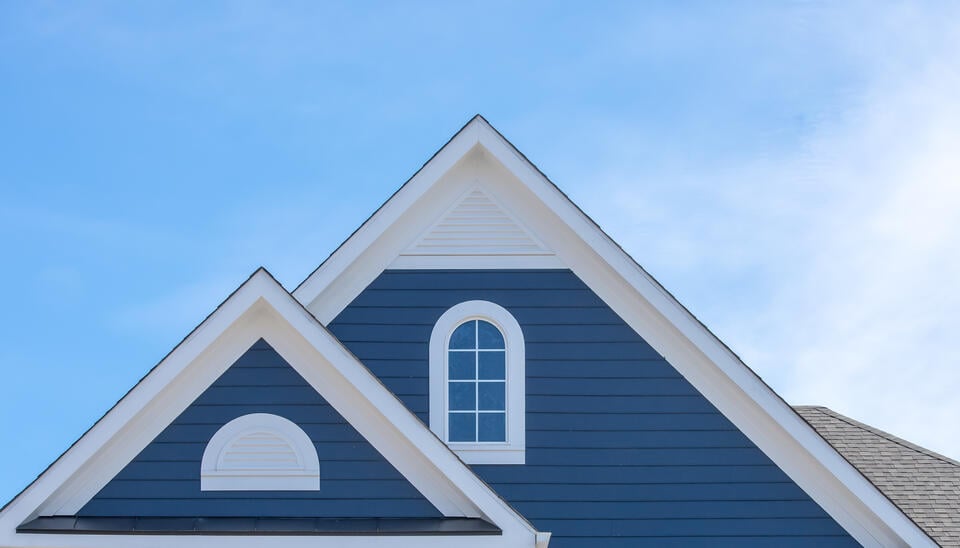 siding contractors emporia va-close up of blue siding near house peaks