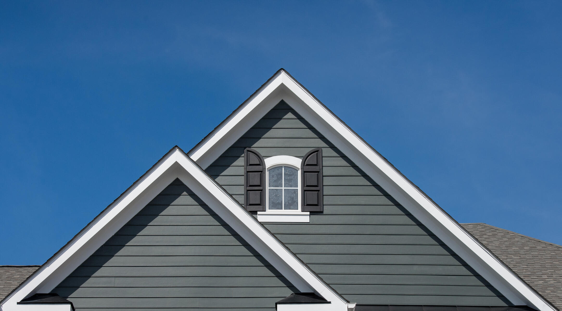 siding contractors franklinton nc-close up of green gray siding near house peaks