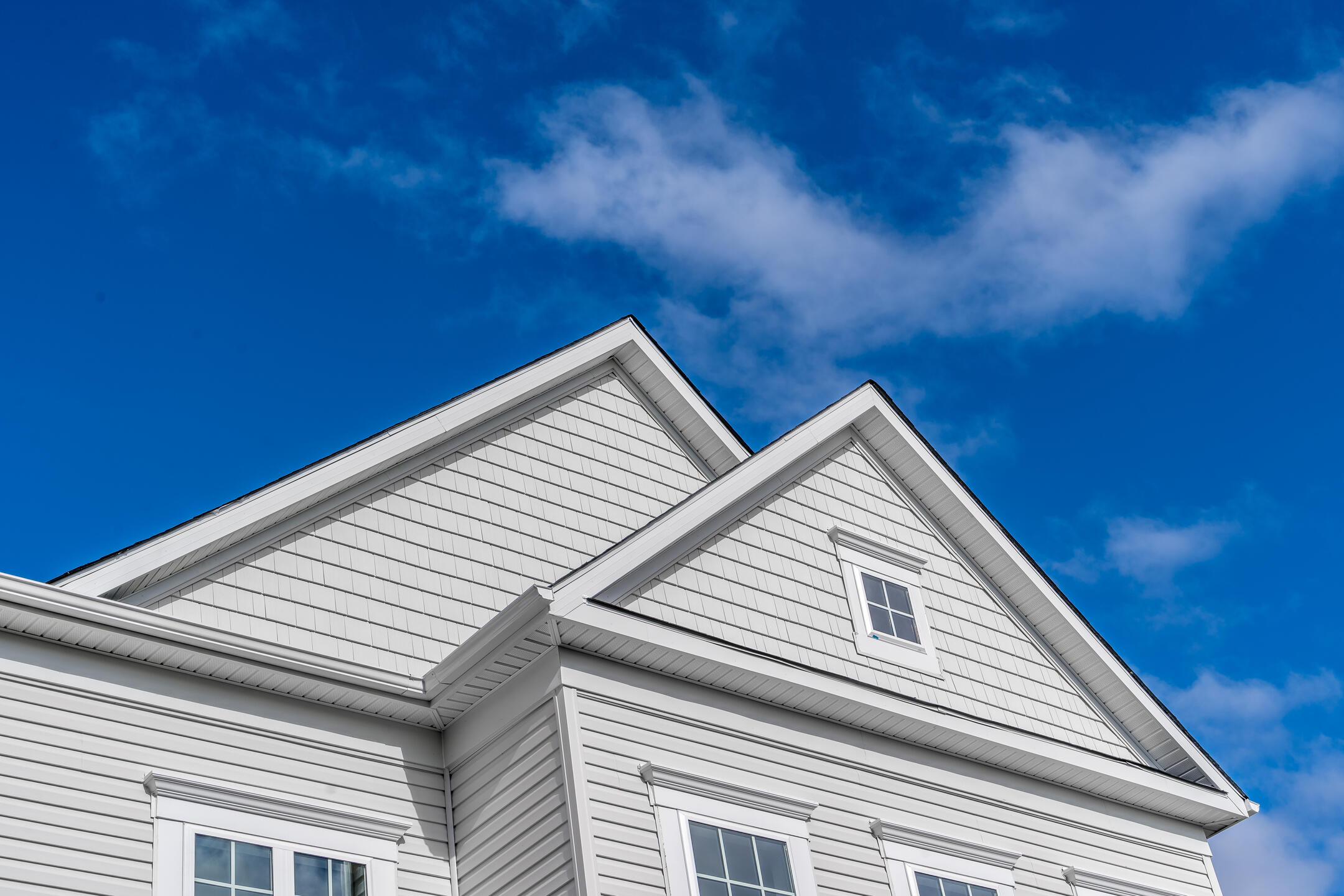 siding contractors henderson nc-house with white siding and blue cloudy sky background