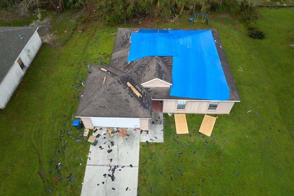 aerial view of roof with tarp on it