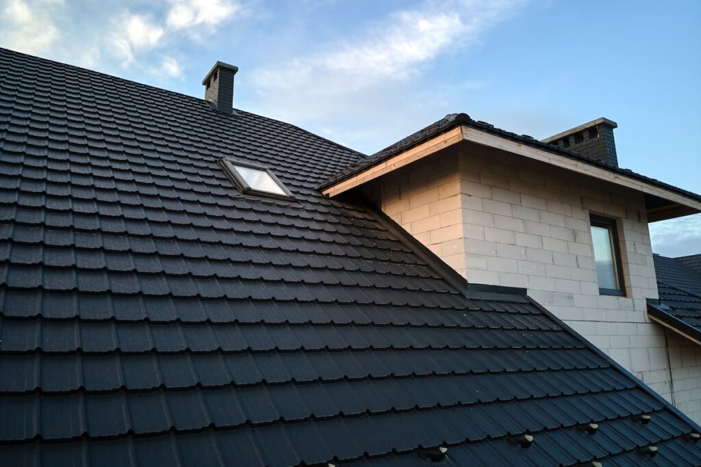 Closeup of house roof top covered with black shingles. 