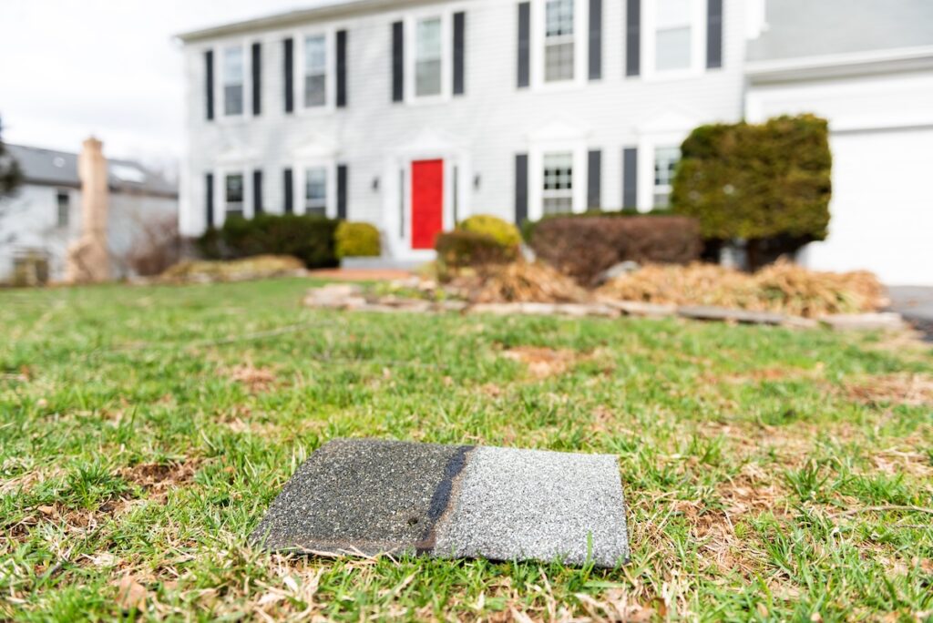 front yard of a house with missing shingle