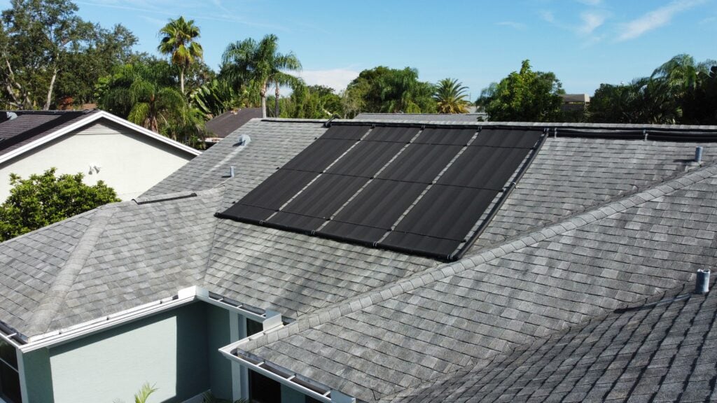 Aerial drone photo of solar panels on shingle roof solar shingles