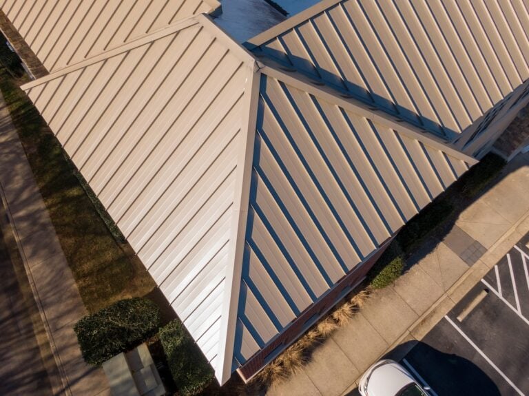 Sunny Day Time Drone Images of Standing Seam Metal Roof on a Commercial Building Also Featuring TPO.