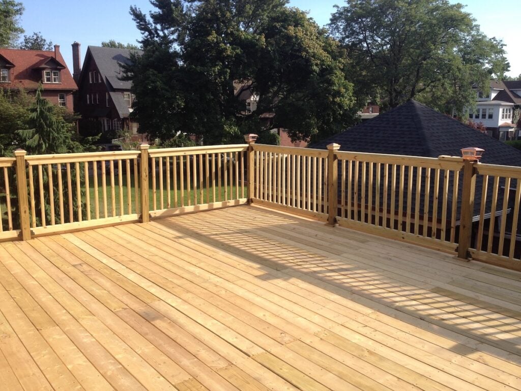 Construction of large wood deck on flat roof garage.