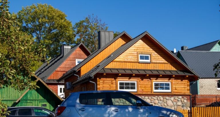 Wooden houses. Classic metal roof. Colorful Houses