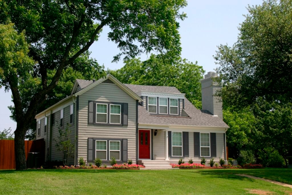 colonial style house with extremely red front door in suburban community