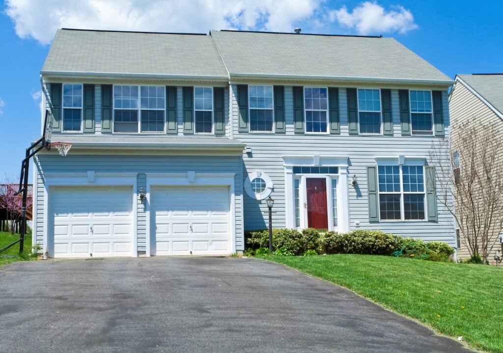 Modern single family house in suburban Maryland. House has a two car garage and a driveway.