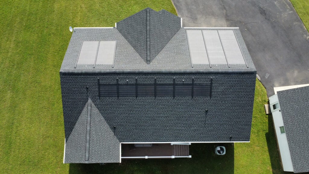 Ariel drone image of a family home with a GAF Timberline Solar roofing system.