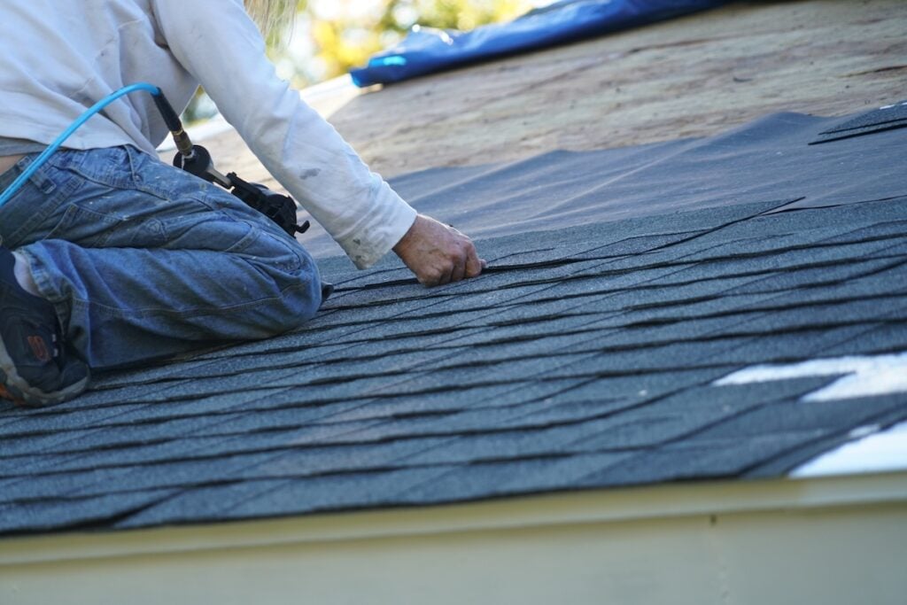 what are starter shingles worker install new shingle on the roof of the house for roof repair