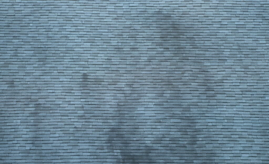 black streaks on roof aged dirty house roof shingle as design background