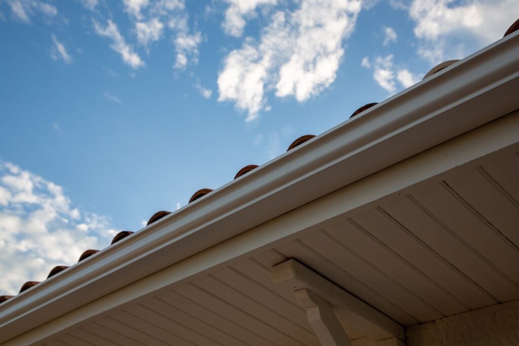 gutter materials new modern house with gutter roof wall under blue cloud sky