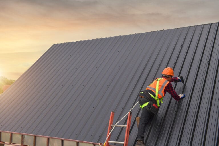 Roofer Construction worker install new roof,Roofing tools,Electric drill used on new roofs with Metal Sheet.