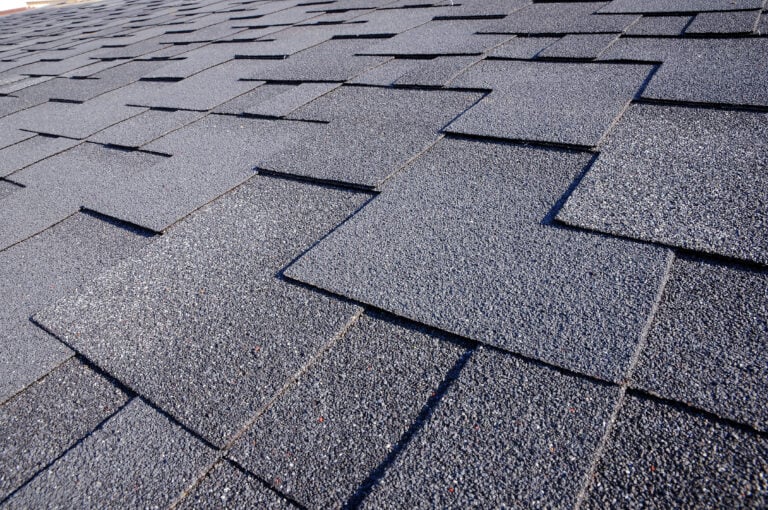 Close up view on Asphalt Roofing Shingles Background. Roof Shingles - Roofing.