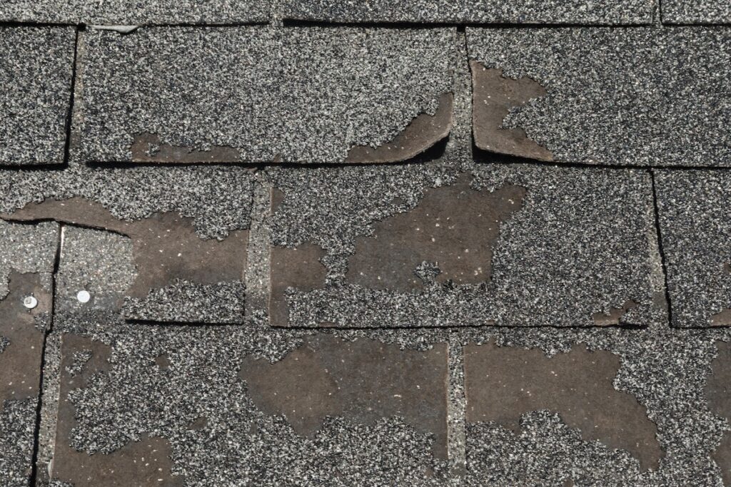 Close up view on Asphalt Roofing Shingles Background. Roof Shingles - Roofing.