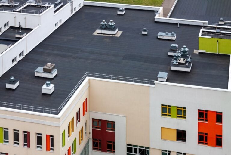 Top view dark flat roof with air conditioners and hydro insulation membranes