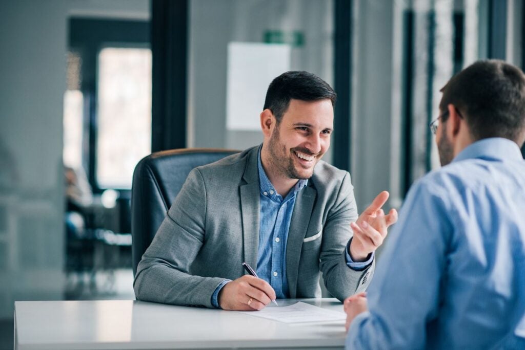 commercial roof warranty two business men talking inside office
