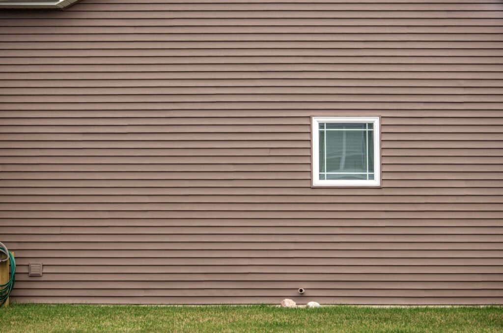 Contemporary tan colored vinyl siding with window