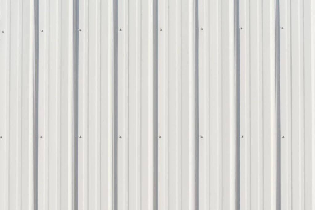 Light gray metal siding with shadows