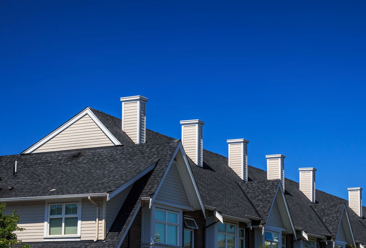 apartment building with dark grey asphalt shingle roof